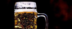Cold pint of craft beer against a black background