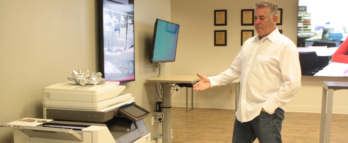 man pointing at copy machine