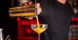 bartender pouring a cocktail