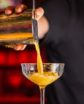 bartender pouring a cocktail