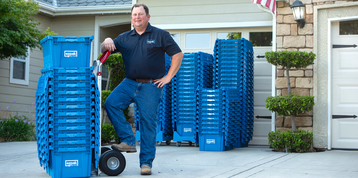 Man posing with plastic bins