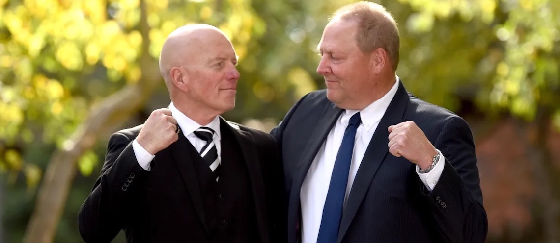 two men jokingly holding fists up to one another