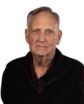 headshot of a man in a black shirt