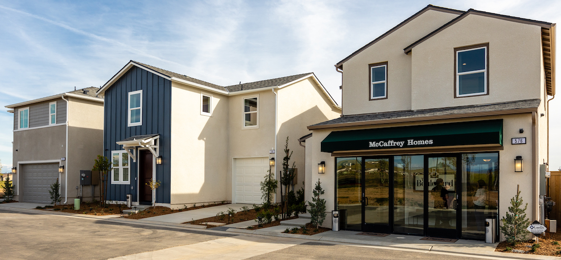 model home and two additional houses on a street