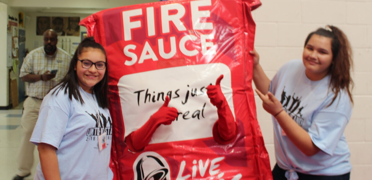 two kids with a sauce packet mascot