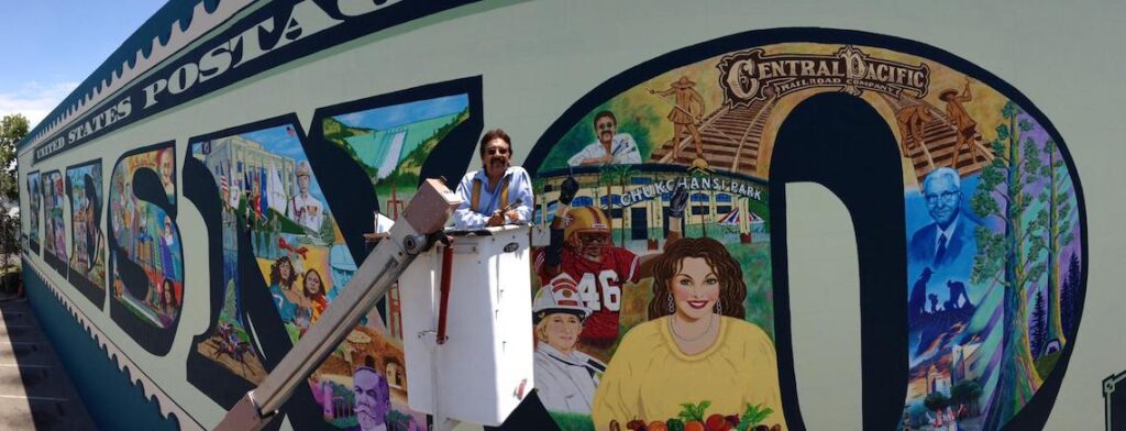 man in front of a mural