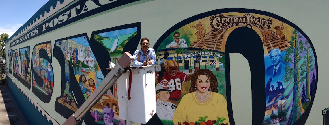 man in front of a mural