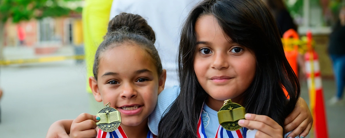 children holding medals