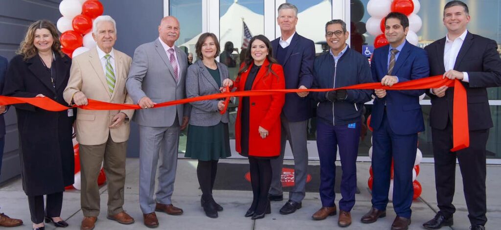 people ready to cut a ribbon