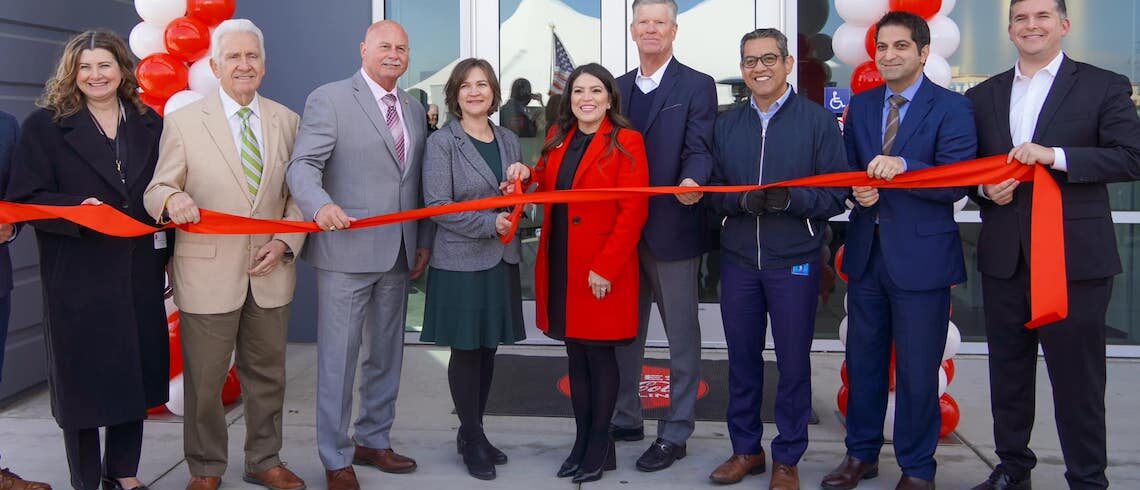 people ready to cut a ribbon