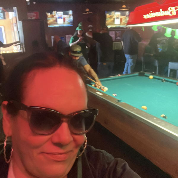 woman in front of pool table