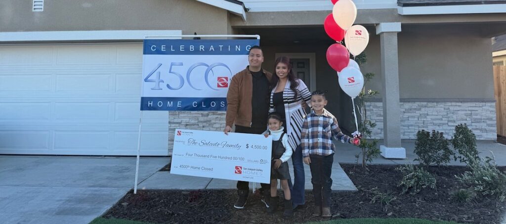 family with a big check