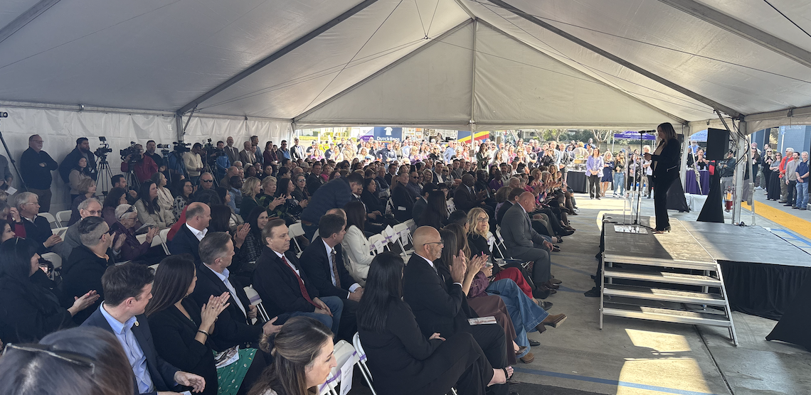 large crowd gathered for a ribbon cutting