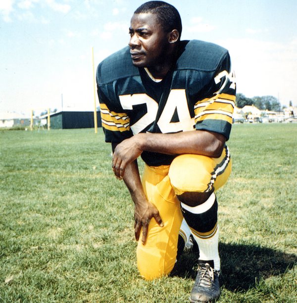 Man kneeling in football uniform
