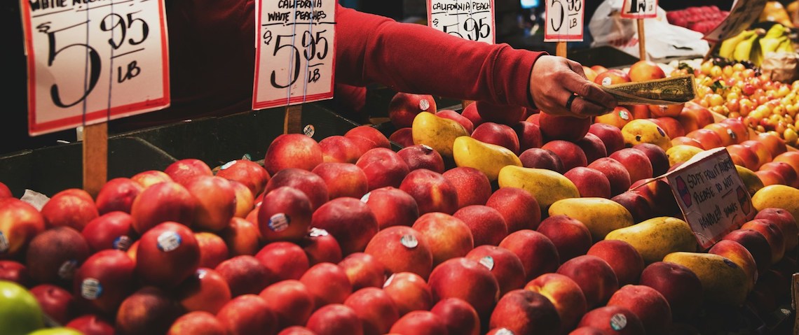 fruit stand vendor reach out to offer change