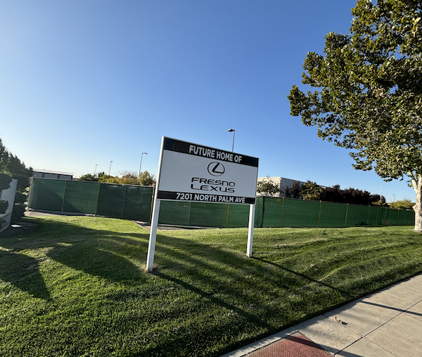 sign on grassy knoll