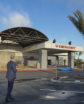 man oversees unveiling of signage on a hospital building