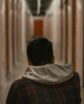 man kneeling in a self storage facility hallway