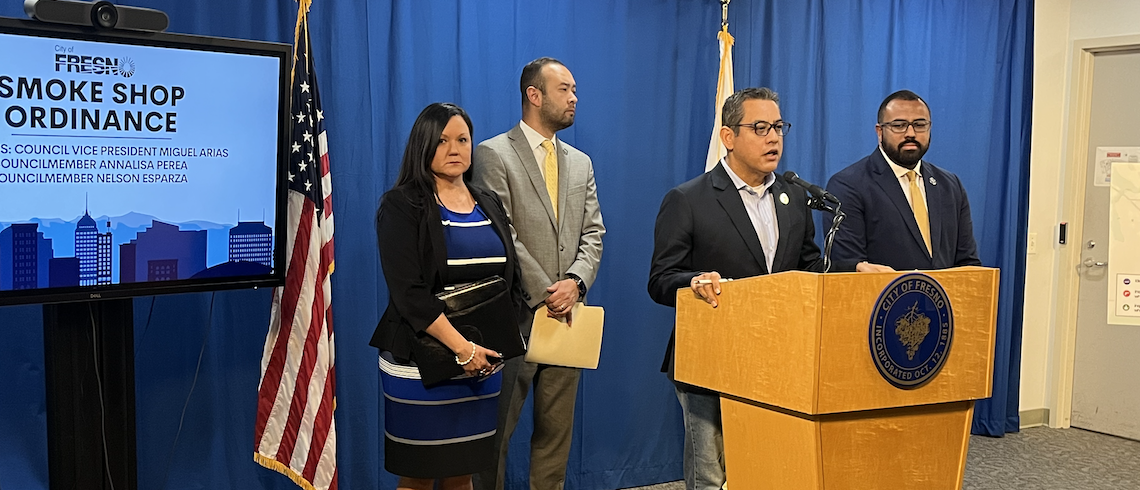 man speaks at podium