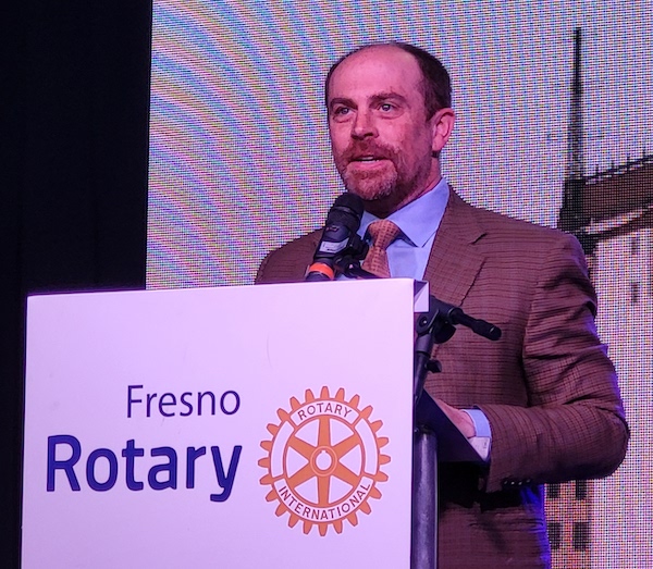 man speaking at podium