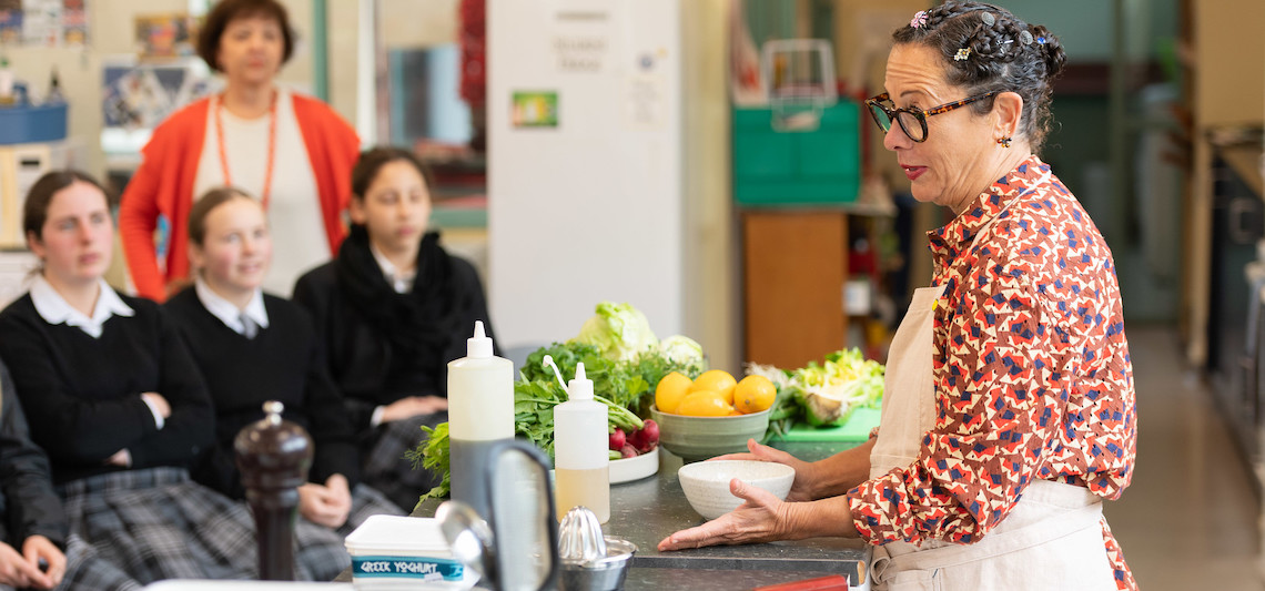 woman chef speaks to girls