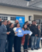 people lined up in front of a house for a photo