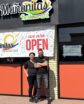 two people in front of a restaurant