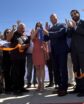 people cutting a ribbon