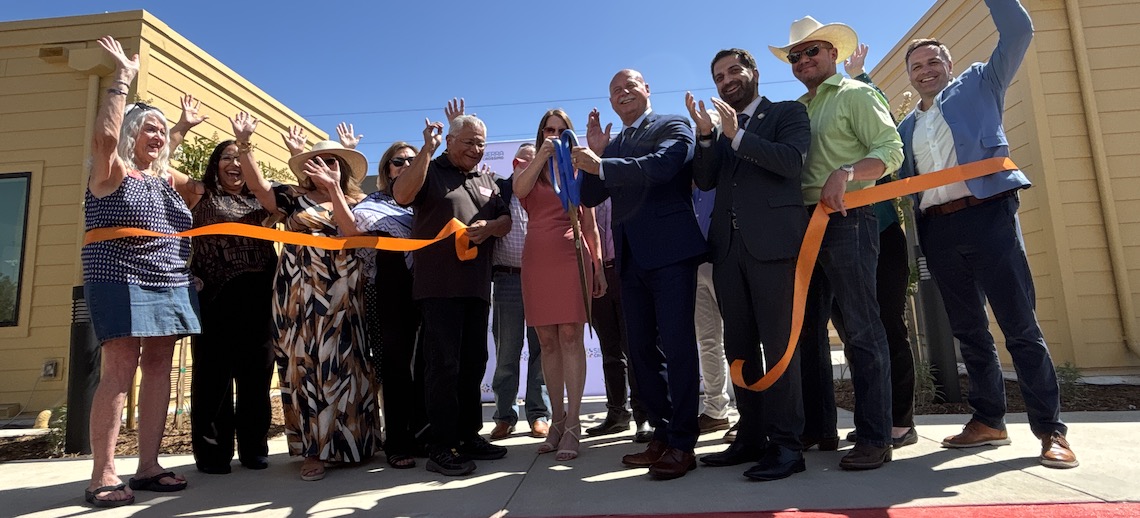 people cutting a ribbon