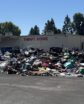 donated items strewn out on a blacktop with building behind