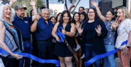 a woman cuts a ribbon