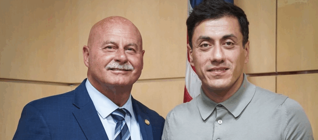 two men pose for a photo