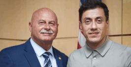 two men pose for a photo