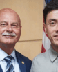 two men pose for a photo