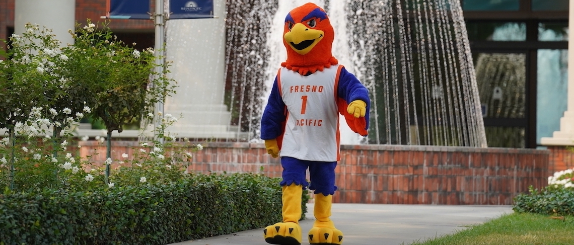 person in a sunbird mascot suit