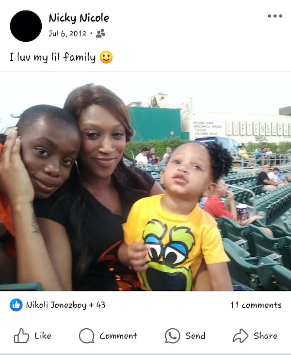 a mom with her two young children at a baseball game