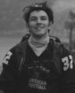 young man wearing a headlamp and backpack, seemingly on a hike