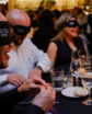 people blindfolded while eating dinner