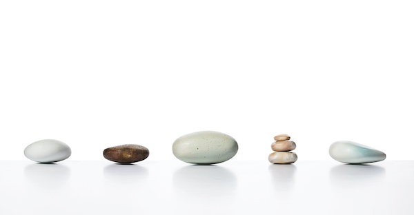 stone lined up in a row. some stacked like a cairn