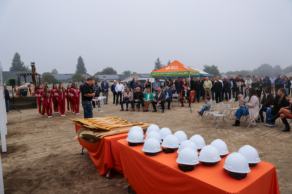 man speaking to a crowd at a groundbreaking event