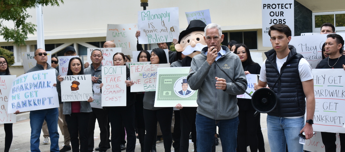 people gathered to listen to a man speaking through megaphone