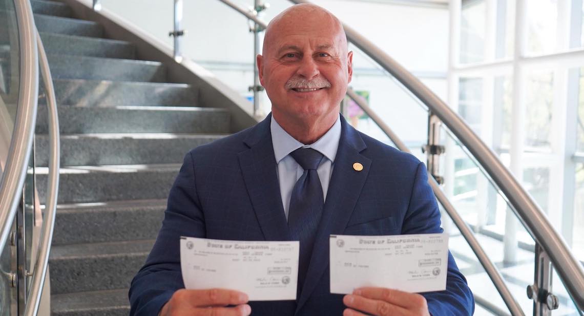man holding checks
