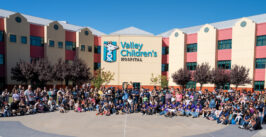 large group photo in front of a hospital
