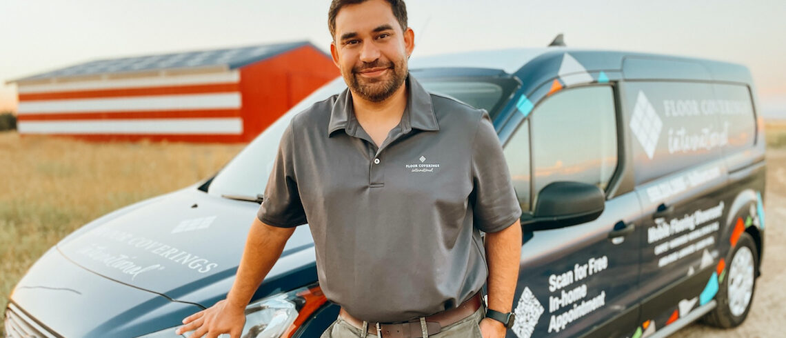 man leaning against a work van