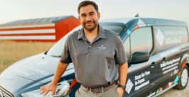 man leaning against a work van