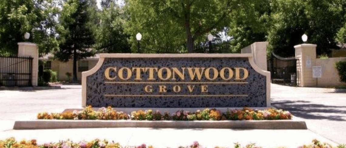 monument sign for an apartment complex called cottonwood grove