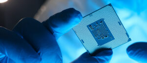 Hands in gloves hold chip testing microelectronics. Setting operating modes electronic controllers. Use chip tuning to increase power. Repair microprocessor electronics electrical equipment