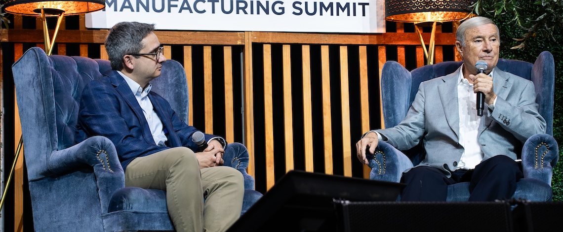 two men on a stage set talking