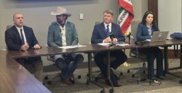 four speakers seated behind a desk