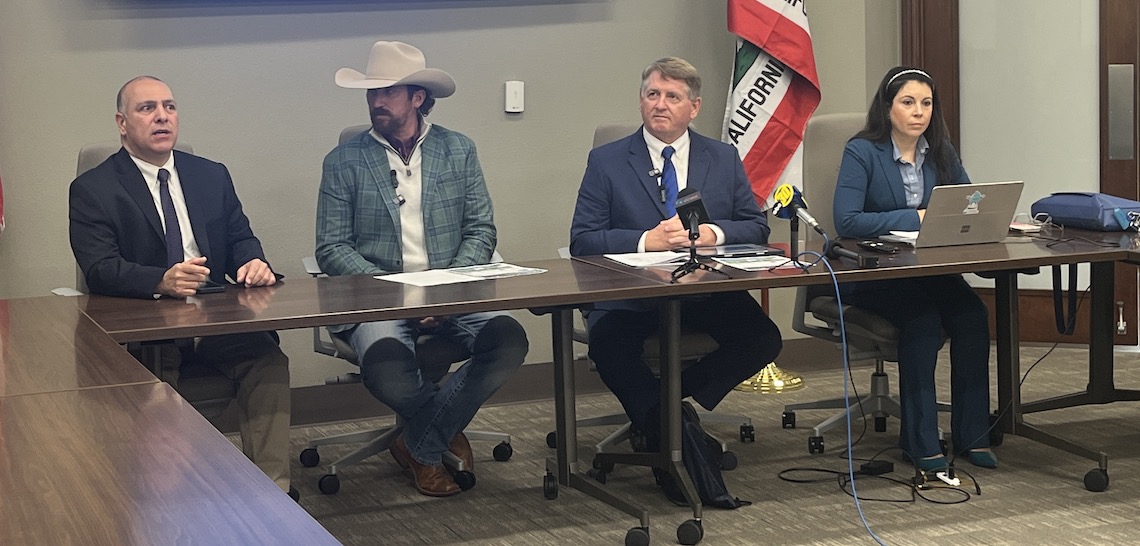 four speakers seated behind a desk